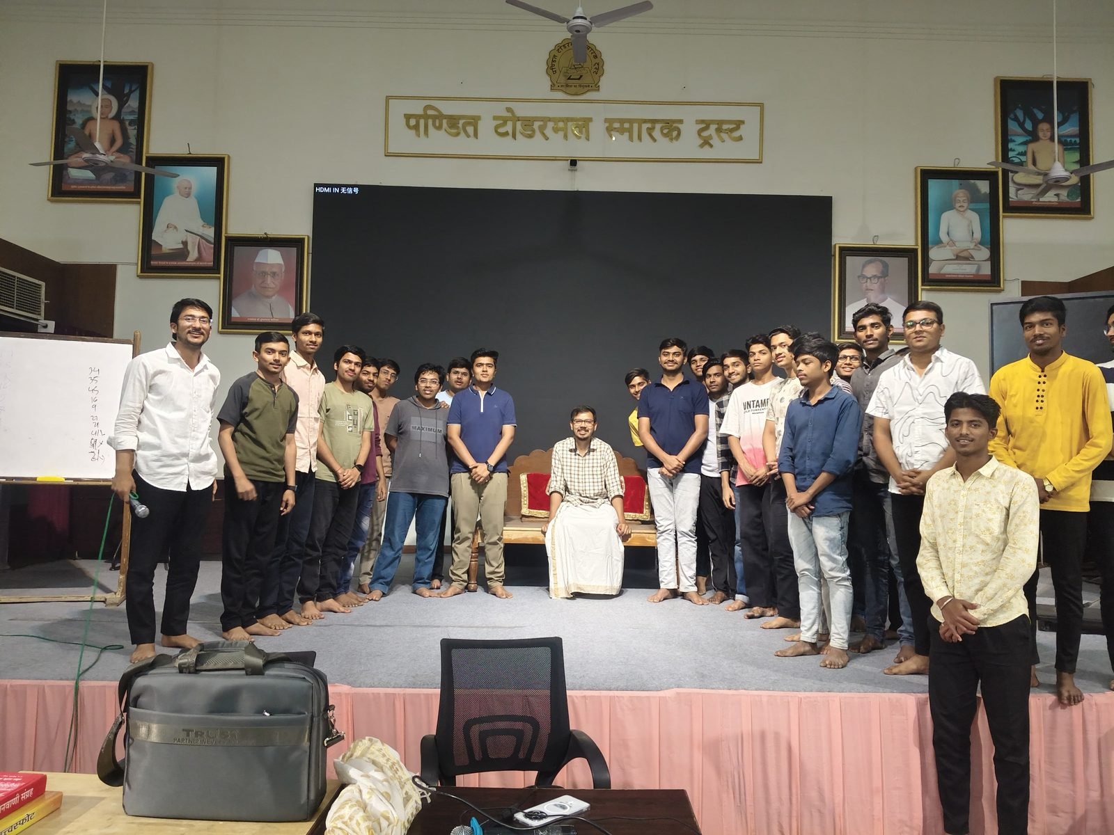 Participants standing in rows on the stage of the Todarmal hall